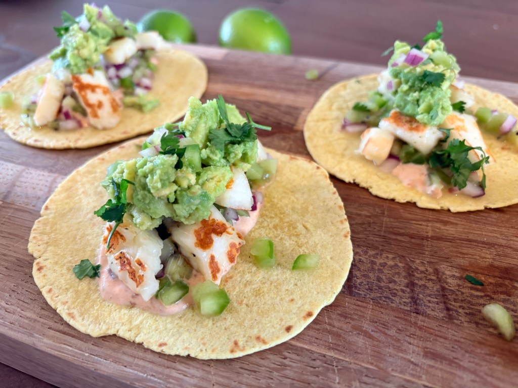 Halloumi tacos with kiwi salsa close up on a wooden board